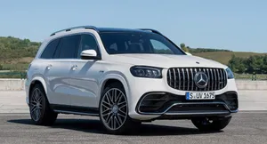 A Happy Family Ready For A Road Trip In Their Stylish Car Wallpaper