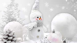 A Happy Festive Snowman Surrounded By Snow Covered Trees, Twinkling Stars, And A Beautiful Night Sky. Wallpaper