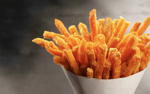 A Hearty Bucket Of Crispy French Fries Wallpaper