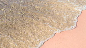 A Hidden Paradise: Breathtaking View Of The Stunning Pink Beach Wallpaper