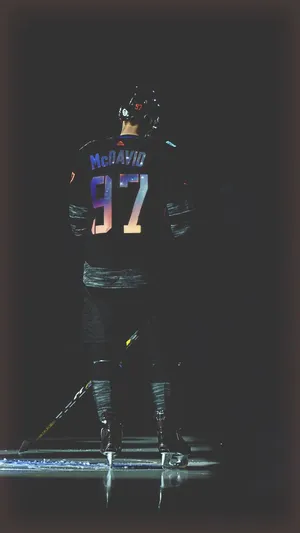 A Hockey Player Is Standing On The Ice Wallpaper