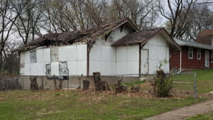 A House With A Fence And A Fence In The Background Wallpaper