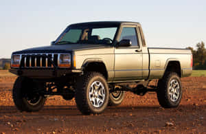 A Jeep Comanche Pickup Truck In The Wilderness. Wallpaper