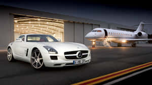 A Jet And A Luxury Red Convertible Showcasing Speed And Style. Wallpaper