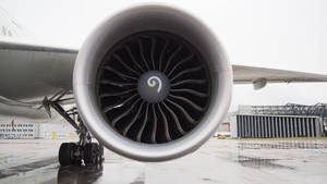 A Jet Engine Sitting At An Airport Wallpaper