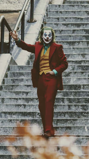 A Joker Walking Down Some Stairs Wallpaper