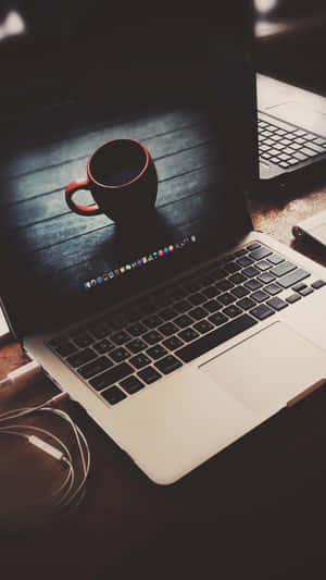 A Laptop On A Table Wallpaper