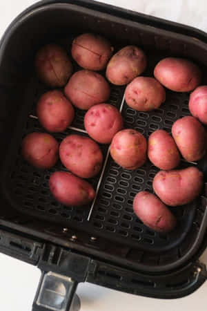 A Large Pile Of Fresh And Nutritious Red Potatoes Wallpaper