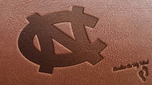 A Leather Notebook With The North Carolina Logo On It Wallpaper