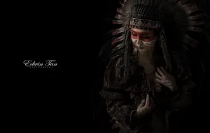 A Lone Blackfeet Native American Man Stands On The Slope Of A Mountain And Looks Out At The Horizon Wallpaper