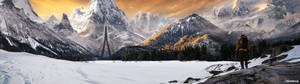 A Lone Hiker Admires A Majestic Mountain Range From Below. Wallpaper