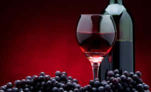 A Luxurious Pour - An Astounding Display Of Red Wine In A Glass Wallpaper