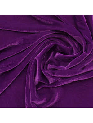 A Luxurious Velvety Purple Fabric Draped Across An Elegant Chair. Wallpaper