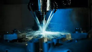 A Machine Is Being Used To Make Metal Parts Wallpaper