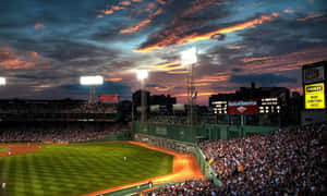 A Majestic Baseball Stadium Under The Night Sky Wallpaper