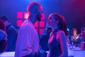 A Man And Woman Standing In A Club Wallpaper