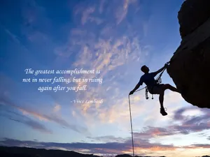A Man Climbing A Cliff With A Quote Wallpaper