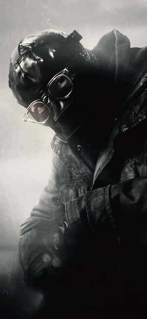 A Man In A Gas Mask Is Holding A Gun Wallpaper