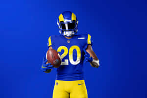 A Man In A Rams Uniform Holding A Football Wallpaper