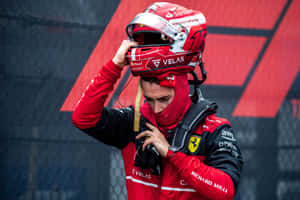 A Man In A Red Helmet Is Holding His Helmet Wallpaper