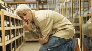 A Man In A Store With Bottles Of Wine Wallpaper