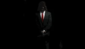 A Man In A Suit And Tie Is Holding A Gun Wallpaper