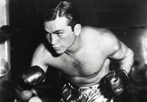 A Man In Boxing Gloves Is Posing For A Photo Wallpaper
