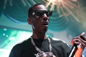 A Man In Sunglasses Is Holding A Microphone Wallpaper