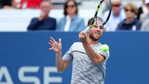 A Man Is Hitting A Tennis Ball Wallpaper