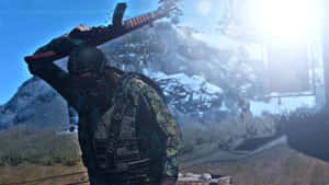 A Man Is Holding A Gun In Front Of A Snowy Mountain Wallpaper