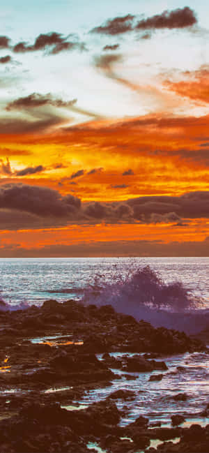 A Man Is Riding A Surfboard On The Beach Wallpaper