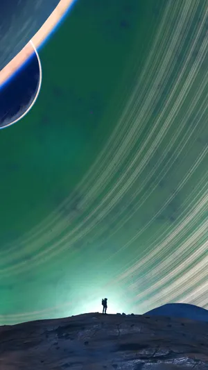 A Man Is Standing On A Hill With Two Planets In The Background Wallpaper