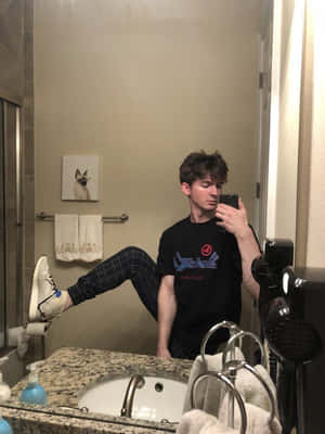 A Man Is Taking A Selfie In A Bathroom Wallpaper