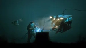 A Man Is Working On A Machine Underwater Wallpaper
