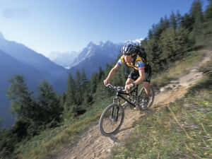 A Man Riding A Mountain Bike Wallpaper