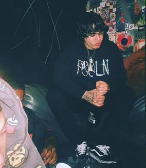 A Man Sitting On A Couch Wallpaper