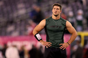 A Man Standing On A Field With His Arms Crossed Wallpaper