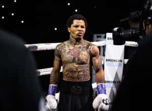 A Man With Tattoos Standing In A Boxing Ring Wallpaper