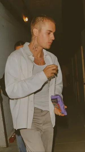 A Man With Tattoos Walking Down The Street Wallpaper