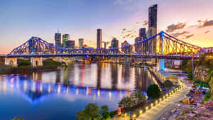 A Mesmerising Sunset Over Brisbane City Skyscrapers Wallpaper