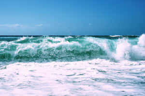 A Mesmerizing Beach Wave At A Sandy Shore Wallpaper