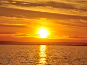 A Mesmerizing Yellow Sunset Over A Beautiful Landscape Wallpaper