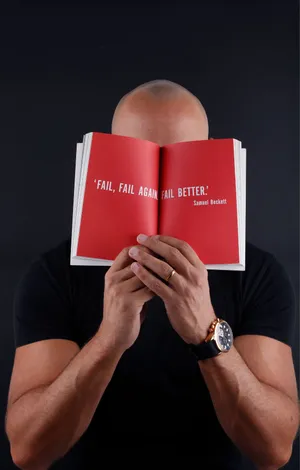 A Middle Aged Bald Man Covering His Face With His Hands Wallpaper