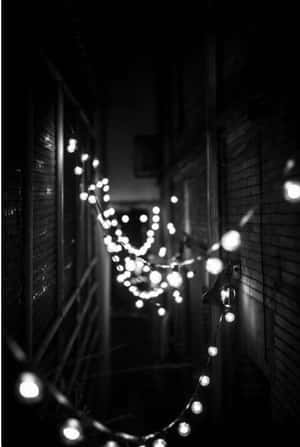 A Minimalist Aesthetic Of A White Iphone With Black Accents Wallpaper