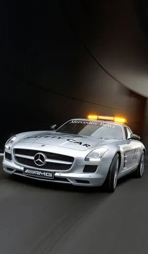 A Modern Yellow Safety Car Actively Guiding The Racecars During A High-speed Race Wallpaper
