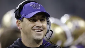 A Motivated Football Coach Strategizing On The Field Wallpaper