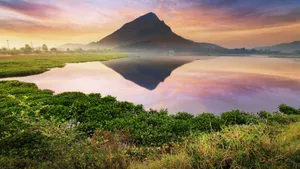 A Mountain Is Reflected In The Water Wallpaper