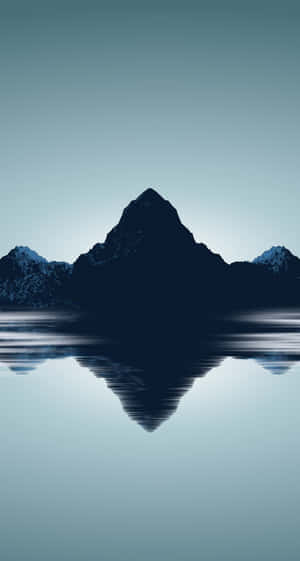 A Mountain Range Is Reflected In The Water Wallpaper