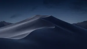 A Mountain With A Dark Sky And A Cloud Wallpaper