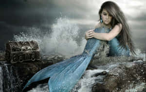 A Mystical Real Mermaid Glides Through The Blue Depths Wallpaper
